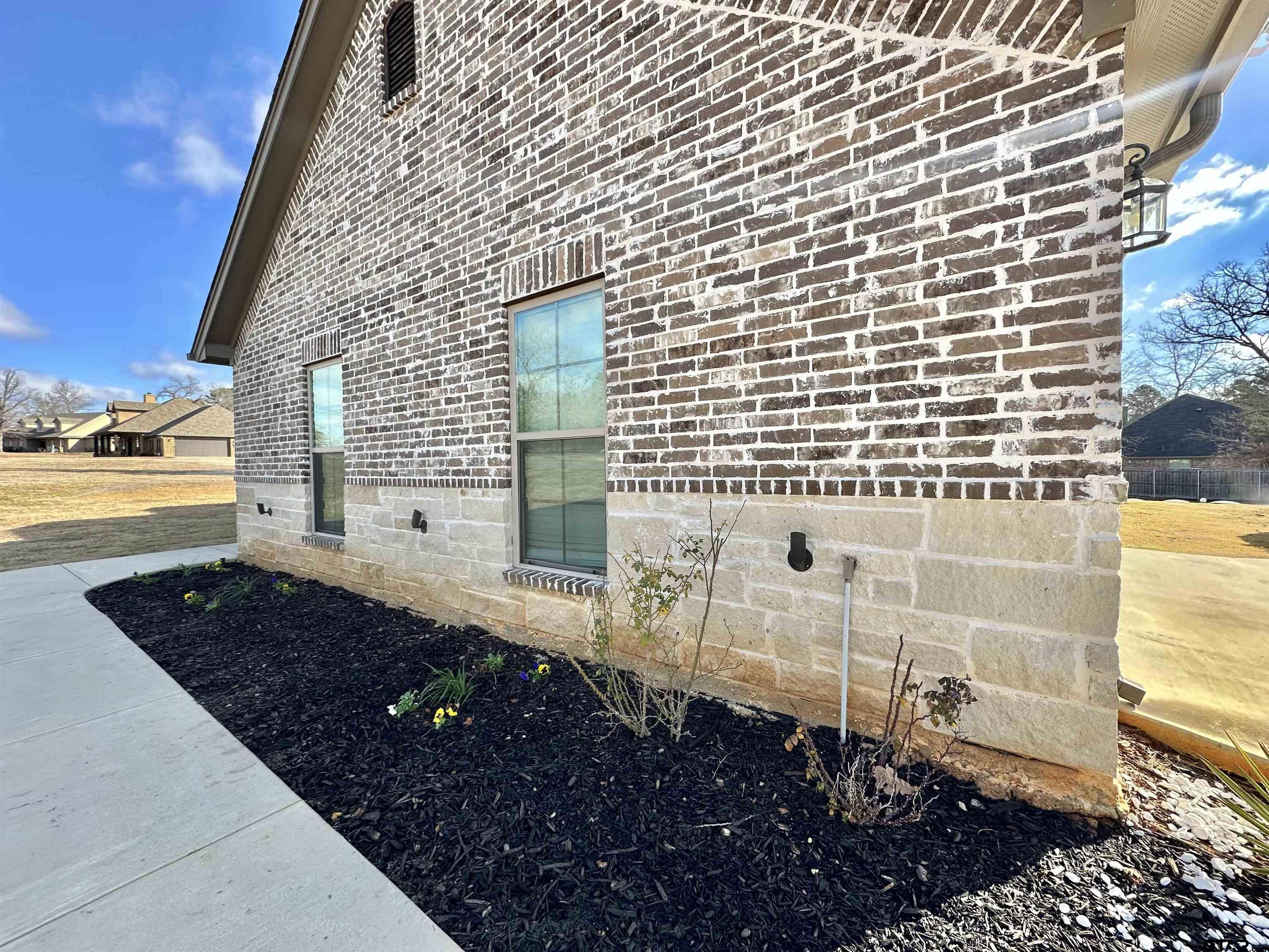 345 Willow Creek Ranch Road Gladewater, TX 75647 - Photo 4 of 47 a view of a brick house with a yard
