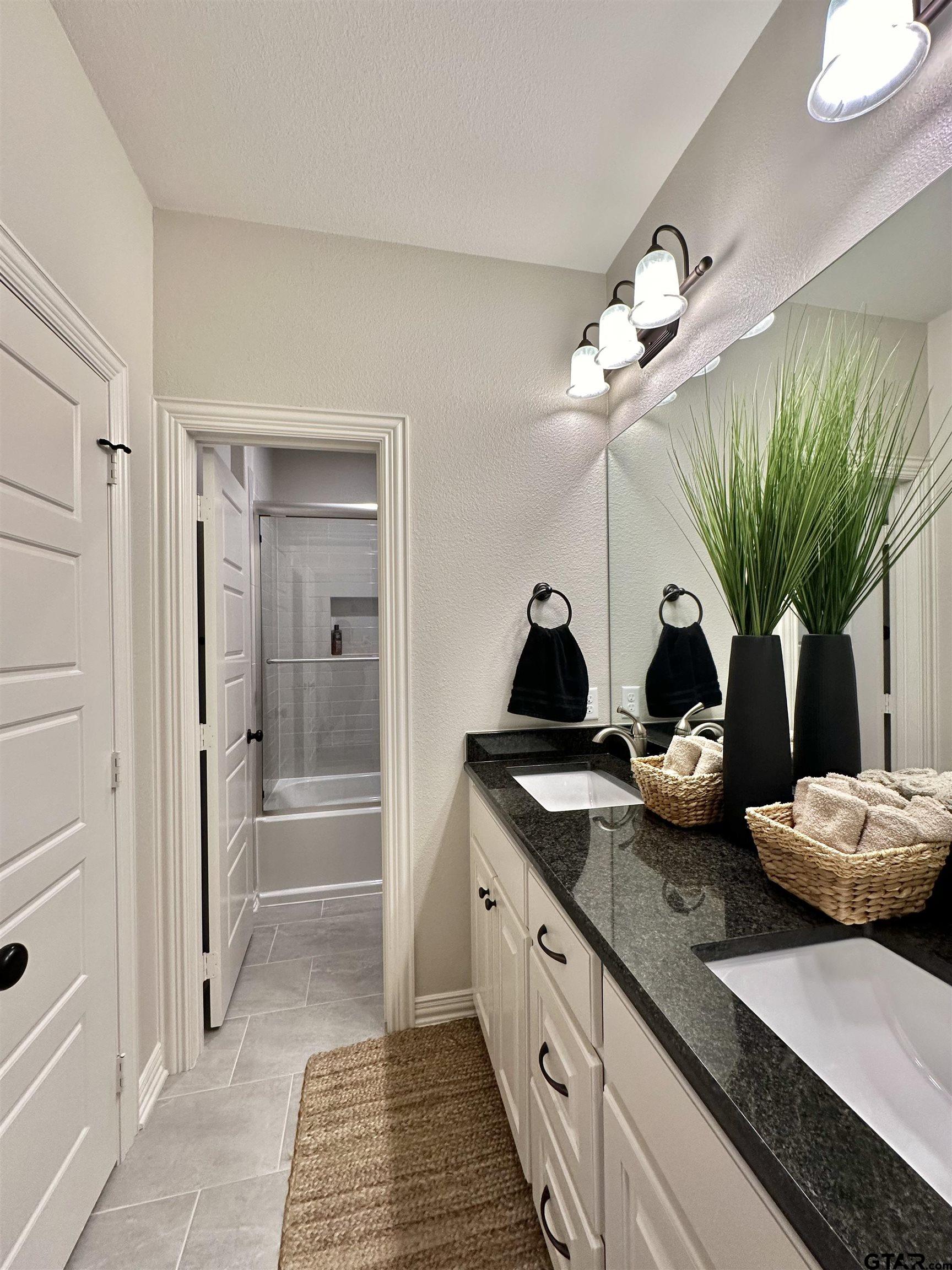 345 Willow Creek Ranch Road Gladewater, TX 75647 - Photo 41 of 47 a view of a double vanity sink and a mirror