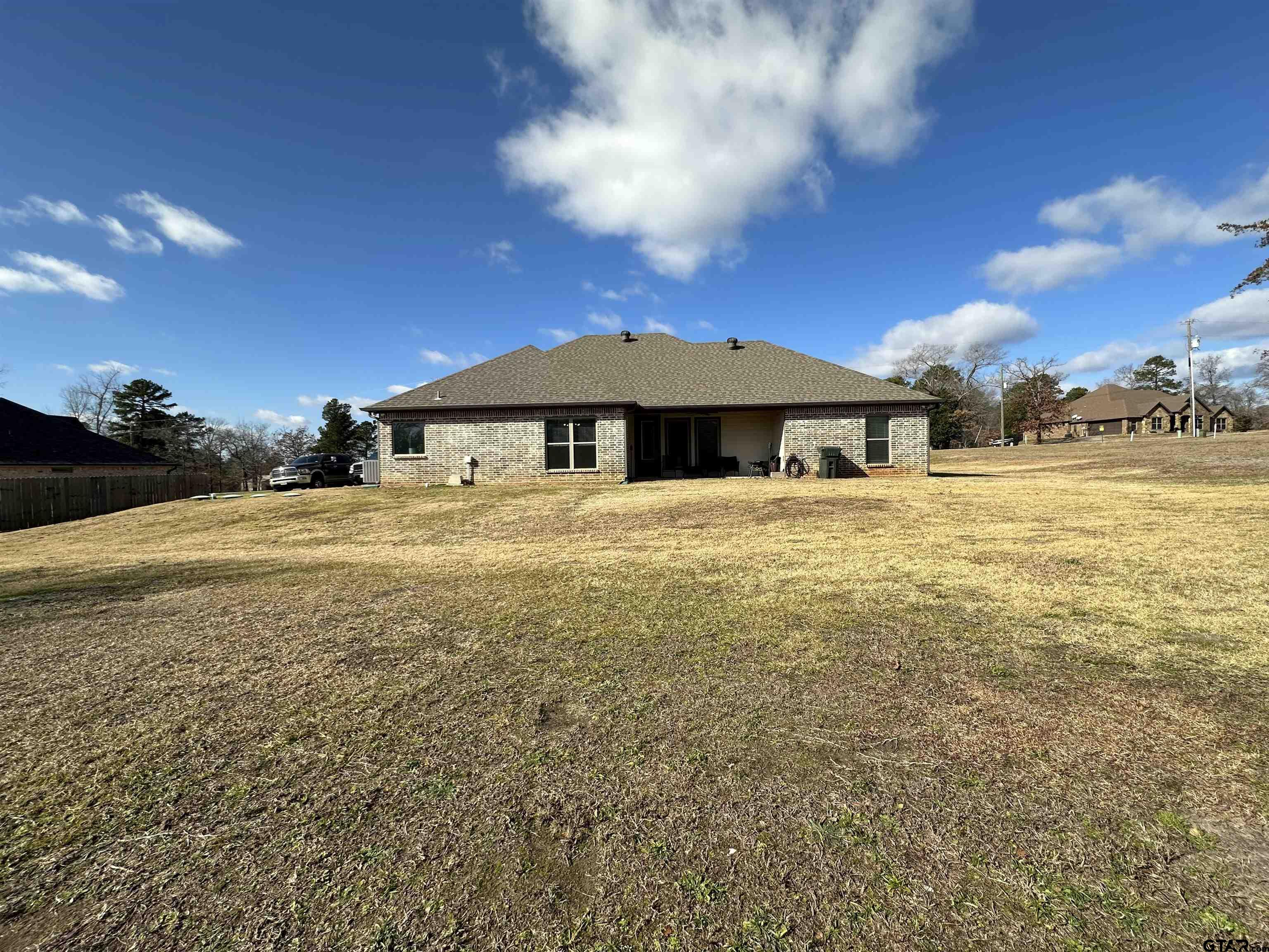 345 Willow Creek Ranch Road Gladewater, TX 75647 - Photo 47 of 47 a view of a large pool with lawn chairs under an umbrella