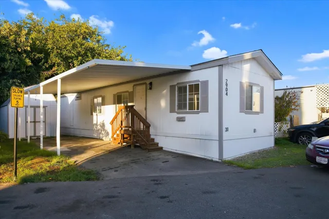 a view of a house with backyard and porch