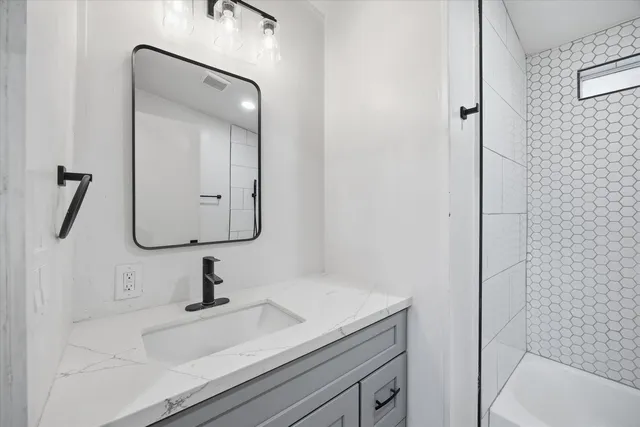 a bathroom with a sink and mirror