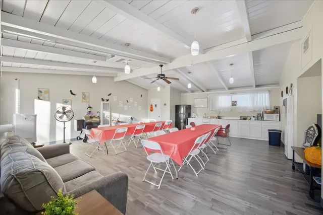 a living room with furniture and kitchen view