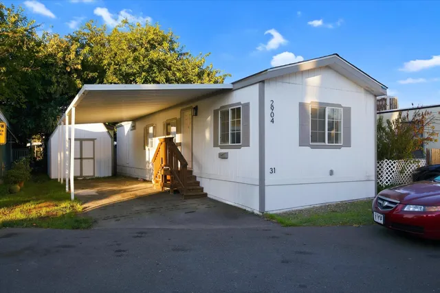 a view of a house with a yard and garage