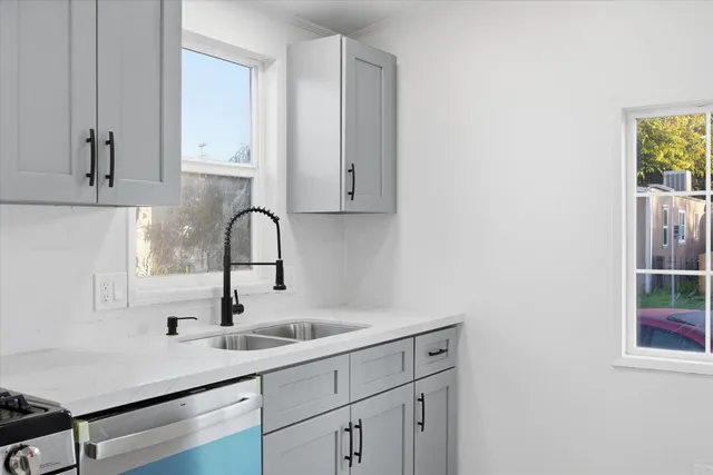 a kitchen with a sink and cabinets