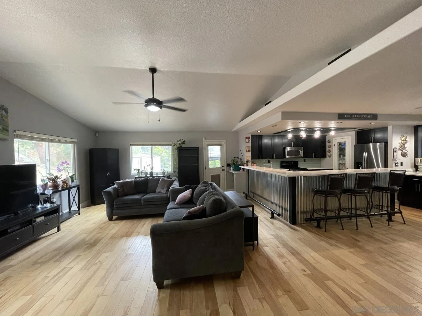 16734 Georgios Way Ramona, CA 92065 - Photo 12 of 35 a living room with furniture and a flat screen tv