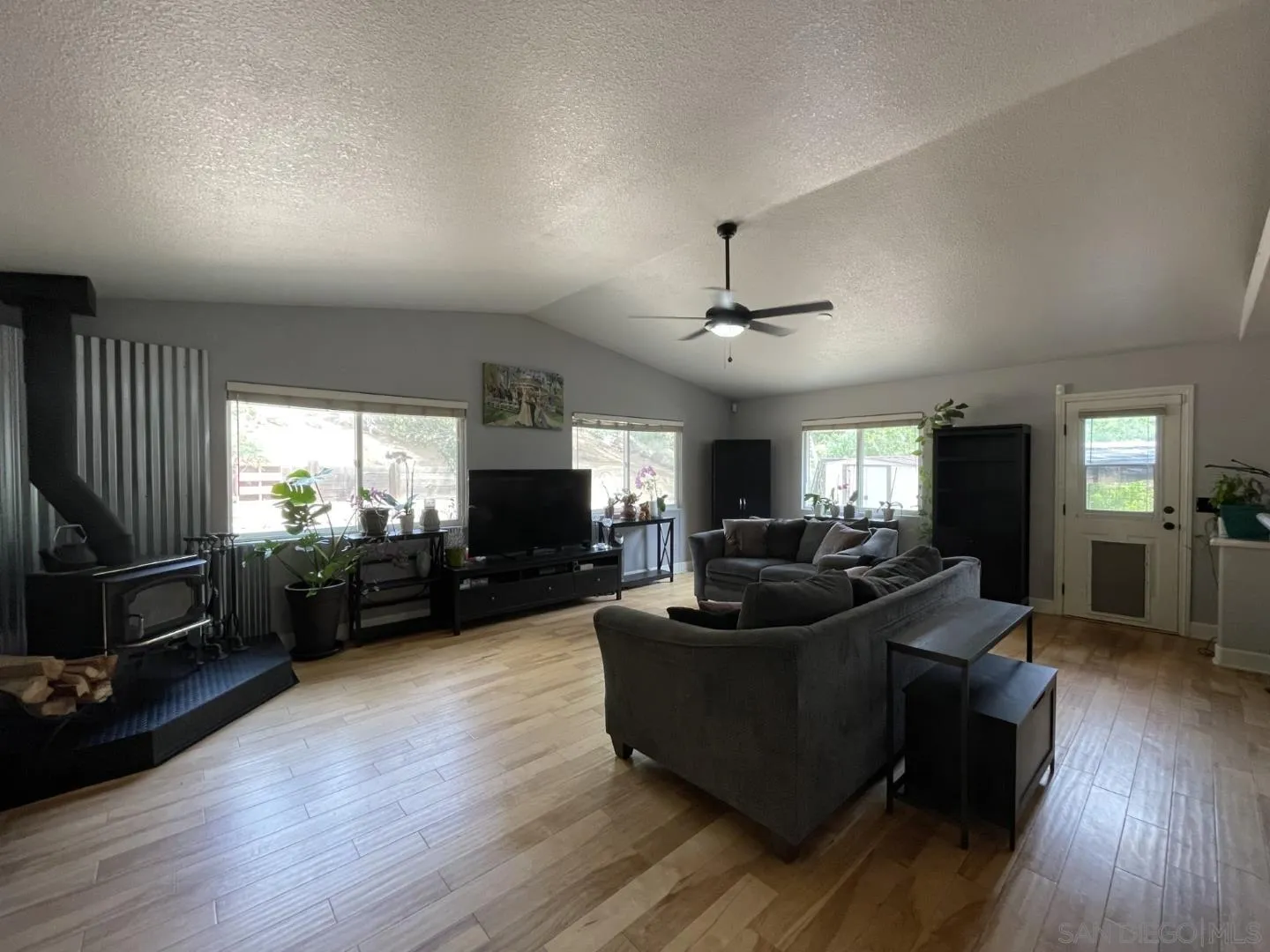 16734 Georgios Way Ramona, CA 92065 - Photo 13 of 35 a living room with furniture flat screen tv and wooden floor