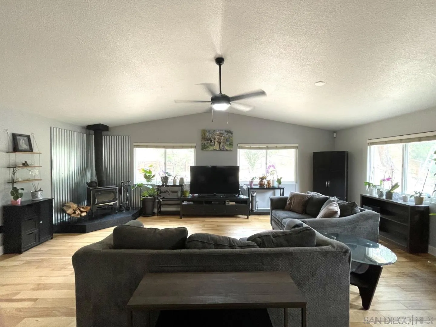 16734 Georgios Way Ramona, CA 92065 - Photo 14 of 35 a living room with fireplace furniture and a chandelier