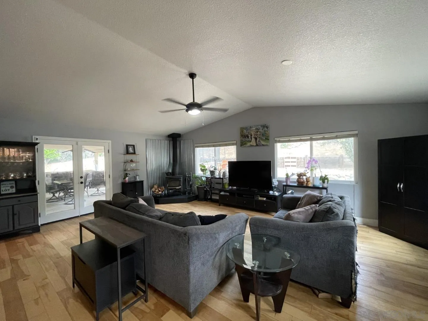 16734 Georgios Way Ramona, CA 92065 - Photo 15 of 35 a living room with furniture and a flat screen tv