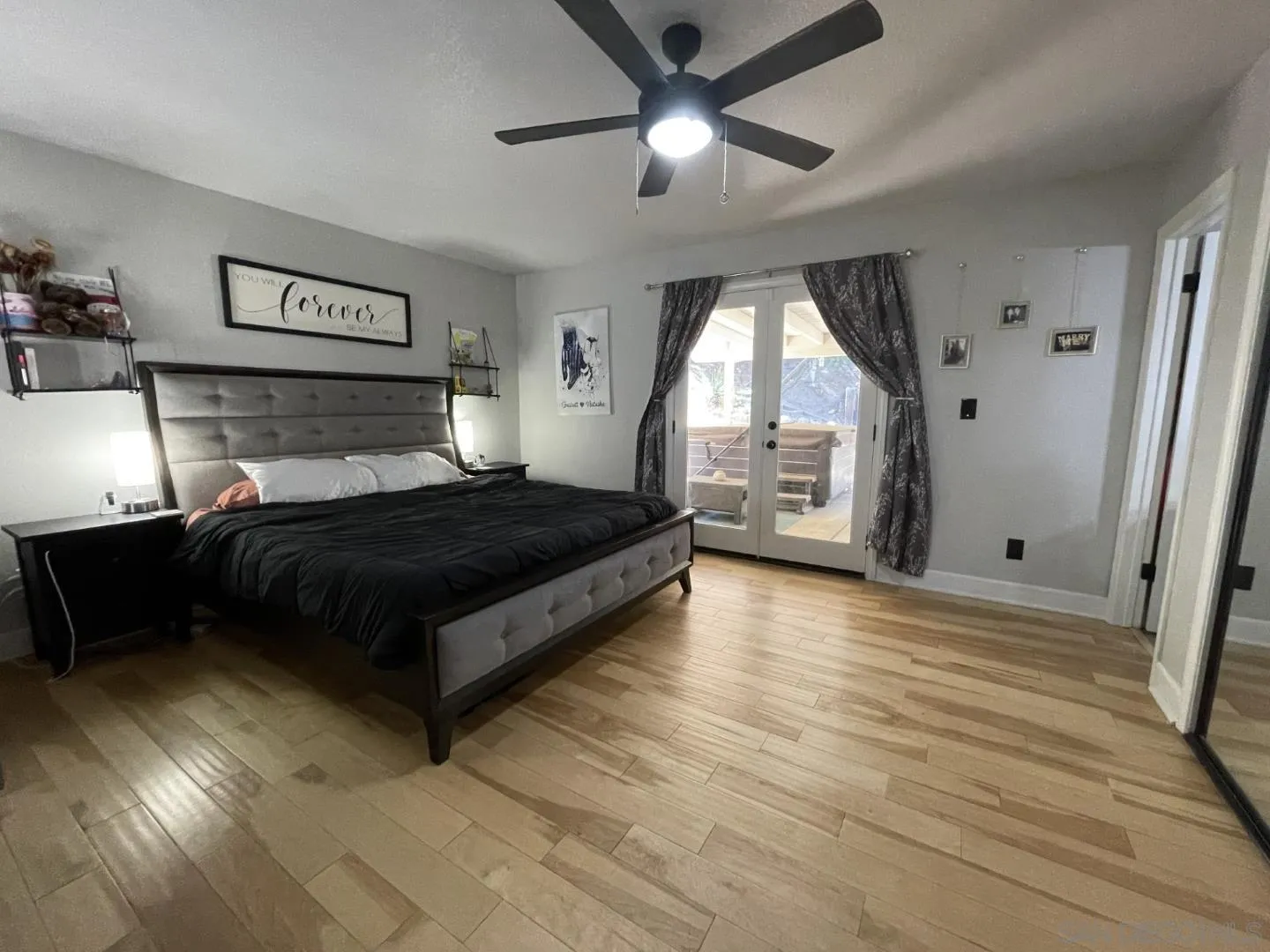 16734 Georgios Way Ramona, CA 92065 - Photo 29 of 35 a bedroom with a bed and wooden floor