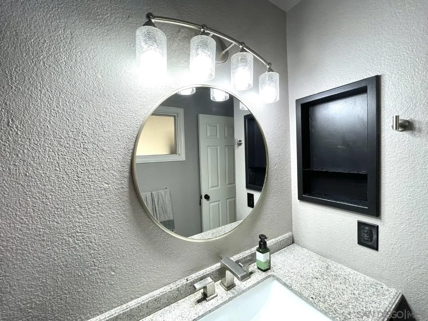 16734 Georgios Way Ramona, CA 92065 - Photo 32 of 35 a bathroom with a mirror and a sink