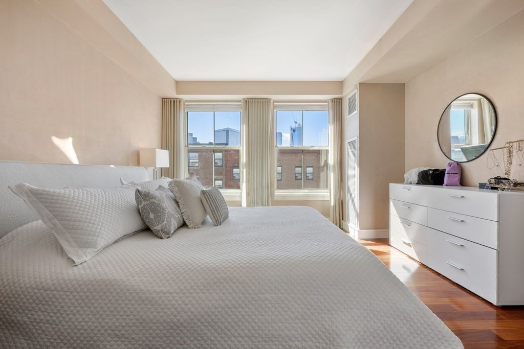 2 Battery Wharf, Unit 2503 Boston, MA 02109 - Photo 13 of 23 a bedroom with a large bed and a dresser