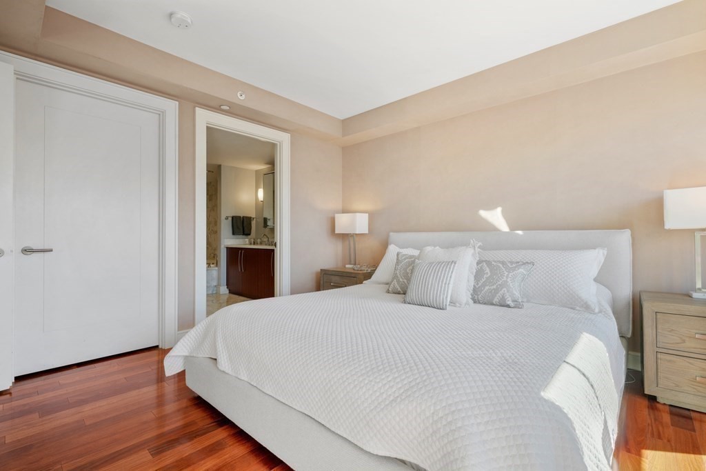 2 Battery Wharf, Unit 2503 Boston, MA 02109 - Photo 14 of 23 a large bed sitting in a bedroom and wooden floor