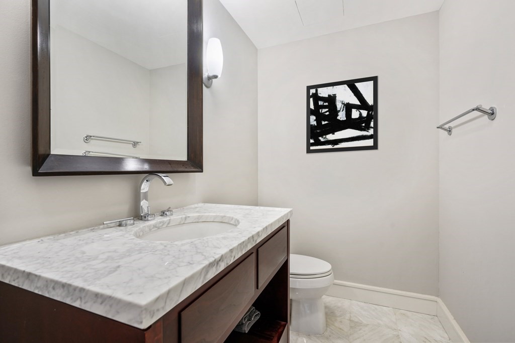 2 Battery Wharf, Unit 2503 Boston, MA 02109 - Photo 15 of 23 a bathroom with a sink a toilet and mirror