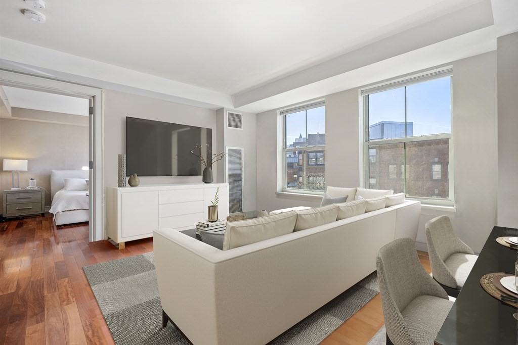 2 Battery Wharf, Unit 2503 Boston, MA 02109 - Photo 3 of 23 a view of living room kitchen with furniture and flat screen tv