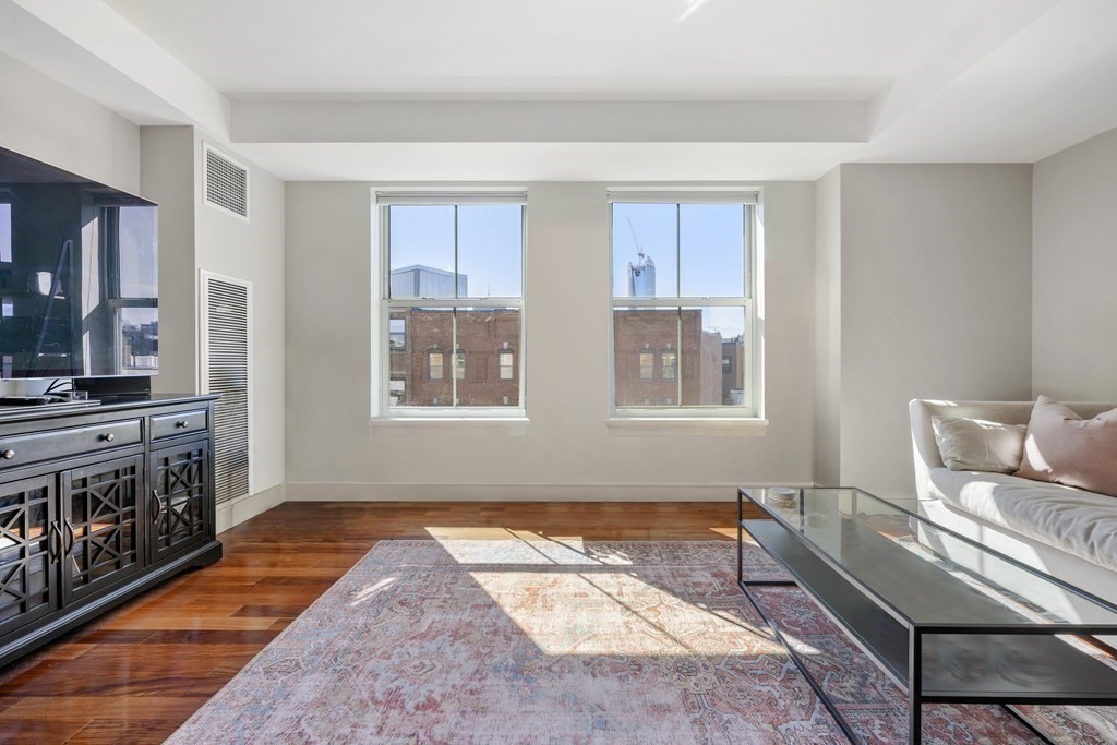 2 Battery Wharf, Unit 2503 Boston, MA 02109 - Photo 4 of 23 a living room with furniture and a flat screen tv