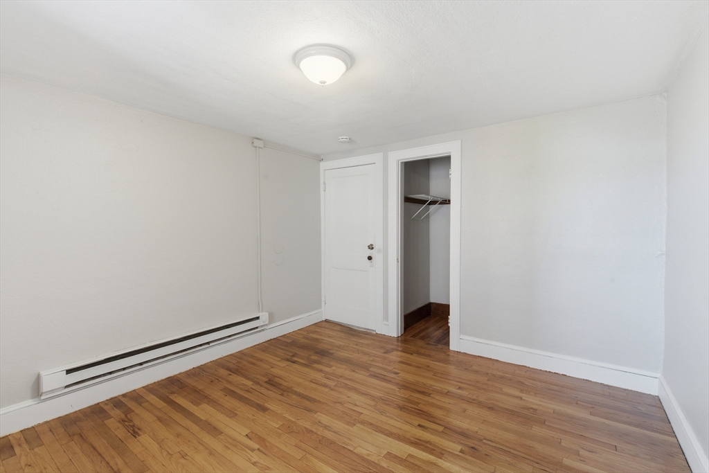 293 Clemente Street, Unit 3R Holyoke, MA 01040 - Photo 11 of 14 a view of an empty room with wooden floor