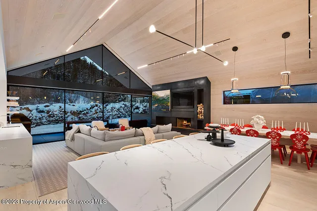 a view of a livingroom with furniture window and kitchen view