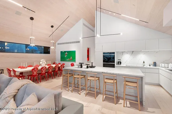 a kitchen with a table chairs and a stove