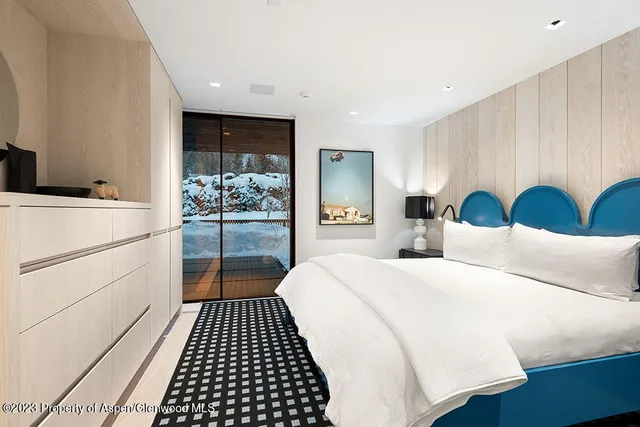 a bedroom with a large bed and a walk in closet