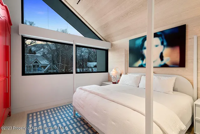 a bedroom with a bed and a painting on the wall