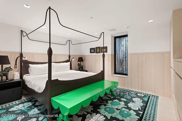 a bed room with furniture and a lamp