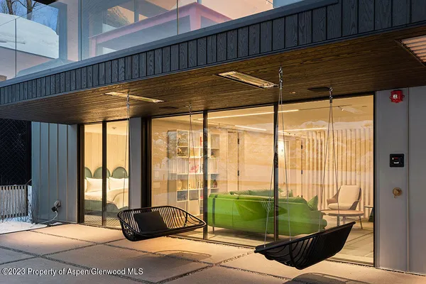 a bedroom with furniture and large windows