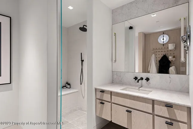 a bathroom with a double vanity sink and mirror