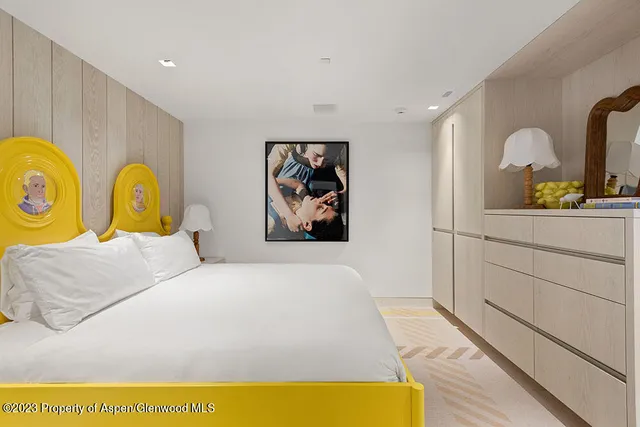 a bedroom with bed and cupboard