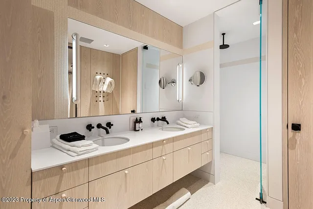 a bathroom with a double vanity sink and mirror