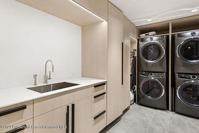 a utility room with sink dryer and washer