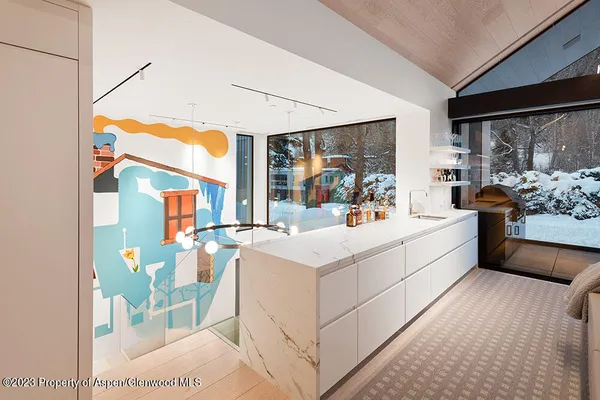 a white bed sitting in a bedroom next to a window