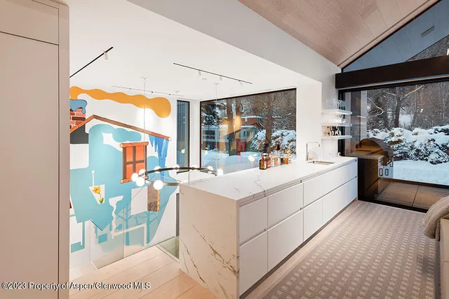 a white bed sitting in a bedroom next to a window