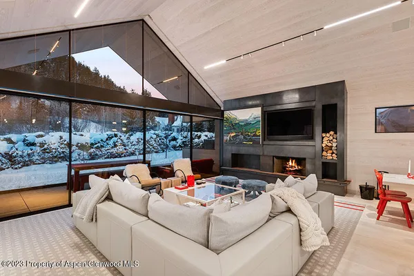 a living room with fireplace furniture and a flat screen tv