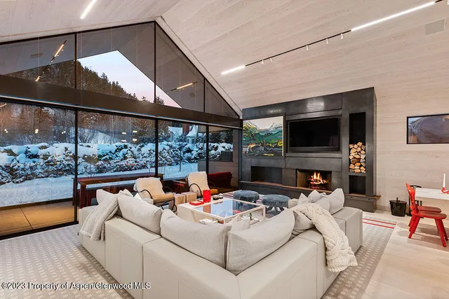 a living room with fireplace furniture and a flat screen tv