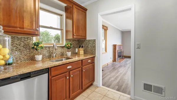 a kitchen with stainless steel appliances granite countertop a sink and cabinets