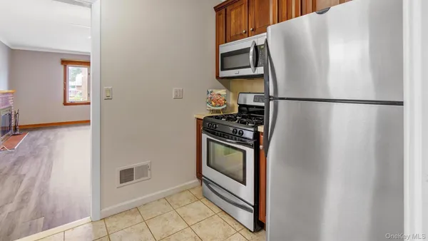 a kitchen with cabinets and stainless steel appliances