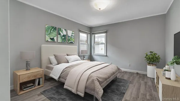 a bedroom with a bed and a potted plant