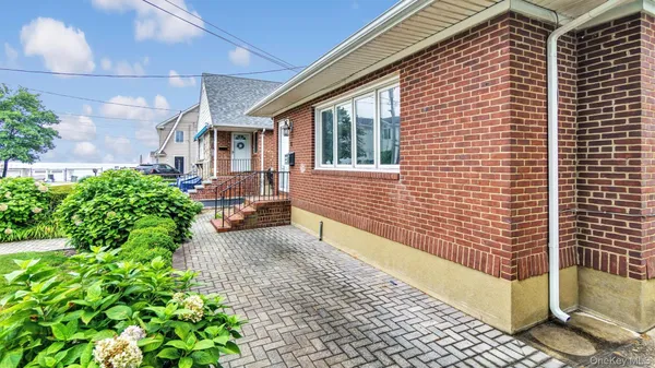 a view of a brick house with a yard
