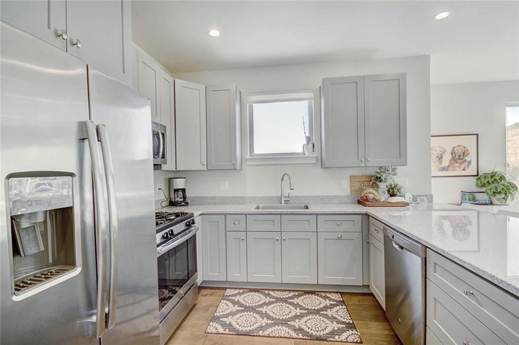 55 Haymaker Street Silverthorne, CO 80498 - Photo 11 of 27 a kitchen with stainless steel appliances a refrigerator sink and cabinets