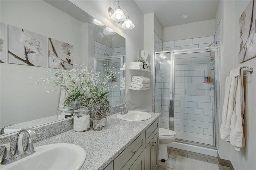 55 Haymaker Street Silverthorne, CO 80498 - Photo 16 of 27 a bathroom with a granite countertop sink a toilet and shower