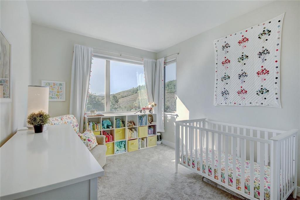 55 Haymaker Street Silverthorne, CO 80498 - Photo 17 of 27 a living room with baby crib and a large window