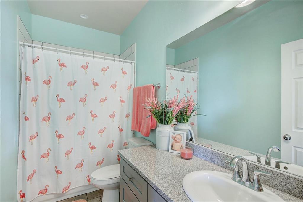 55 Haymaker Street Silverthorne, CO 80498 - Photo 19 of 27 a bathroom with a granite countertop sink a toilet and shower curtain