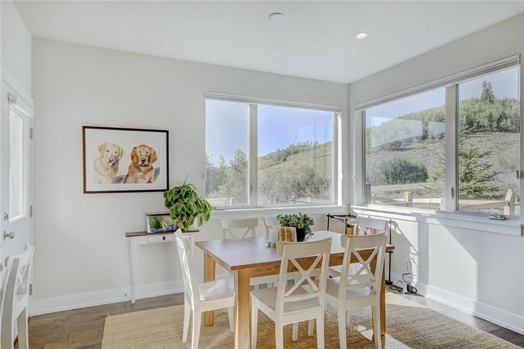 55 Haymaker Street Silverthorne, CO 80498 - Photo 7 of 27 a view of a dining room with furniture large windows and wooden floor