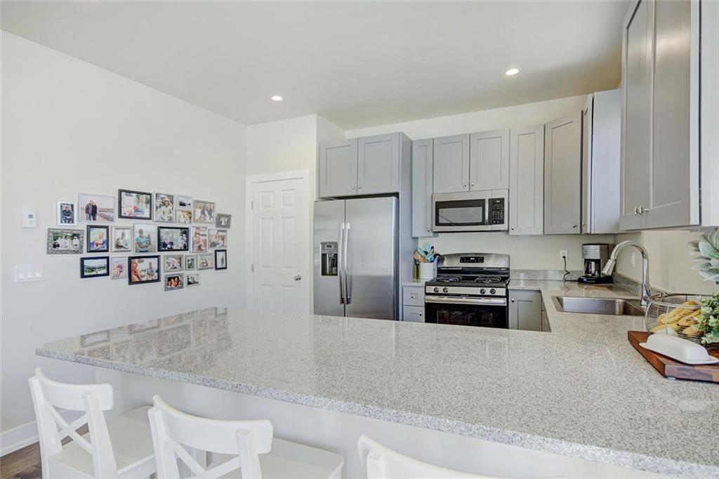 55 Haymaker Street Silverthorne, CO 80498 - Photo 9 of 27 a kitchen with stainless steel appliances granite countertop a refrigerator and a stove top oven