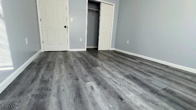 a view of a room with wooden floor and window