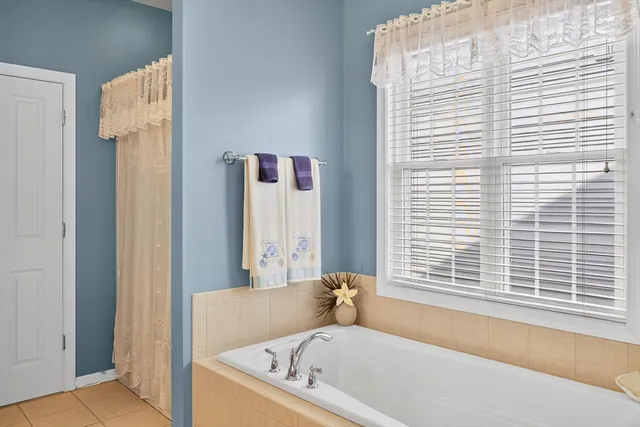 a white bath tub sitting next to a window
