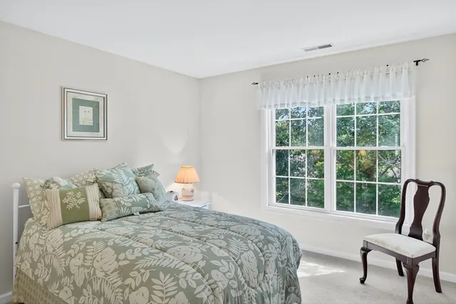 a bedroom with a bed and a chair