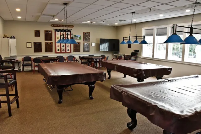 a living room with furniture a flat screen tv and a table