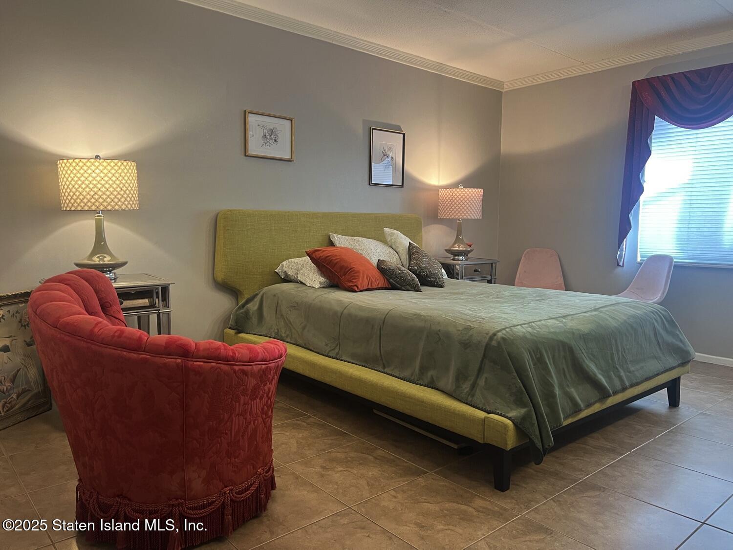 11 Windham Loop, Unit 1NN Staten Island, NY 10314 - Photo 12 of 25 a bedroom with a bed and a lamp