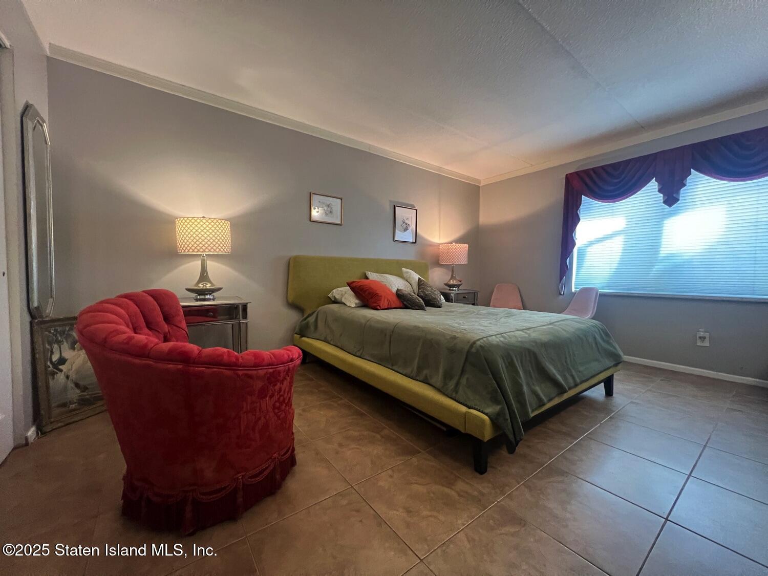 11 Windham Loop, Unit 1NN Staten Island, NY 10314 - Photo 13 of 25 a bedroom with a bed and window